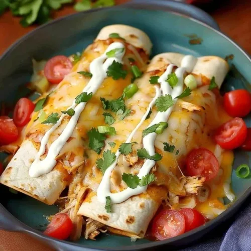 Delicious white rotisserie chicken enchiladas topped with cheese and sauce