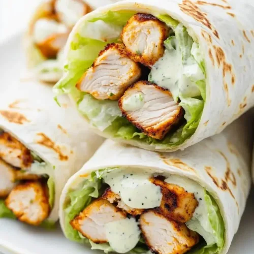 Tasty grilled chicken wraps with fresh vegetables and tasty sauce