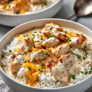 Creamy smothered chicken served with rice, a delicious comfort food dish.
