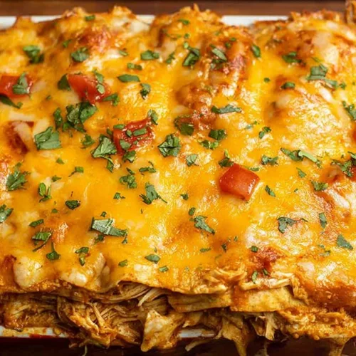 Easy cheesy chicken enchilada casserole topped with melted cheese and fresh toppings.