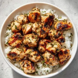 Savory garlic butter chicken bites on a plate, garnished and ready to serve.
