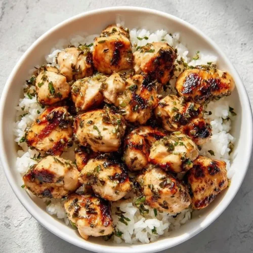 Savory garlic butter chicken bites on a plate, garnished and ready to serve.
