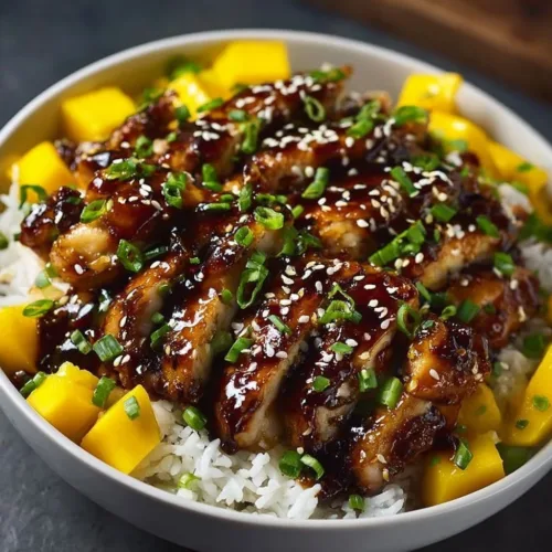 Delicious mango glazed chicken served with fresh herbs and vegetables