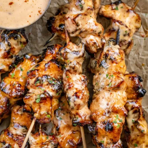 Bang Bang Chicken Skewers with spicy sauce on the grill