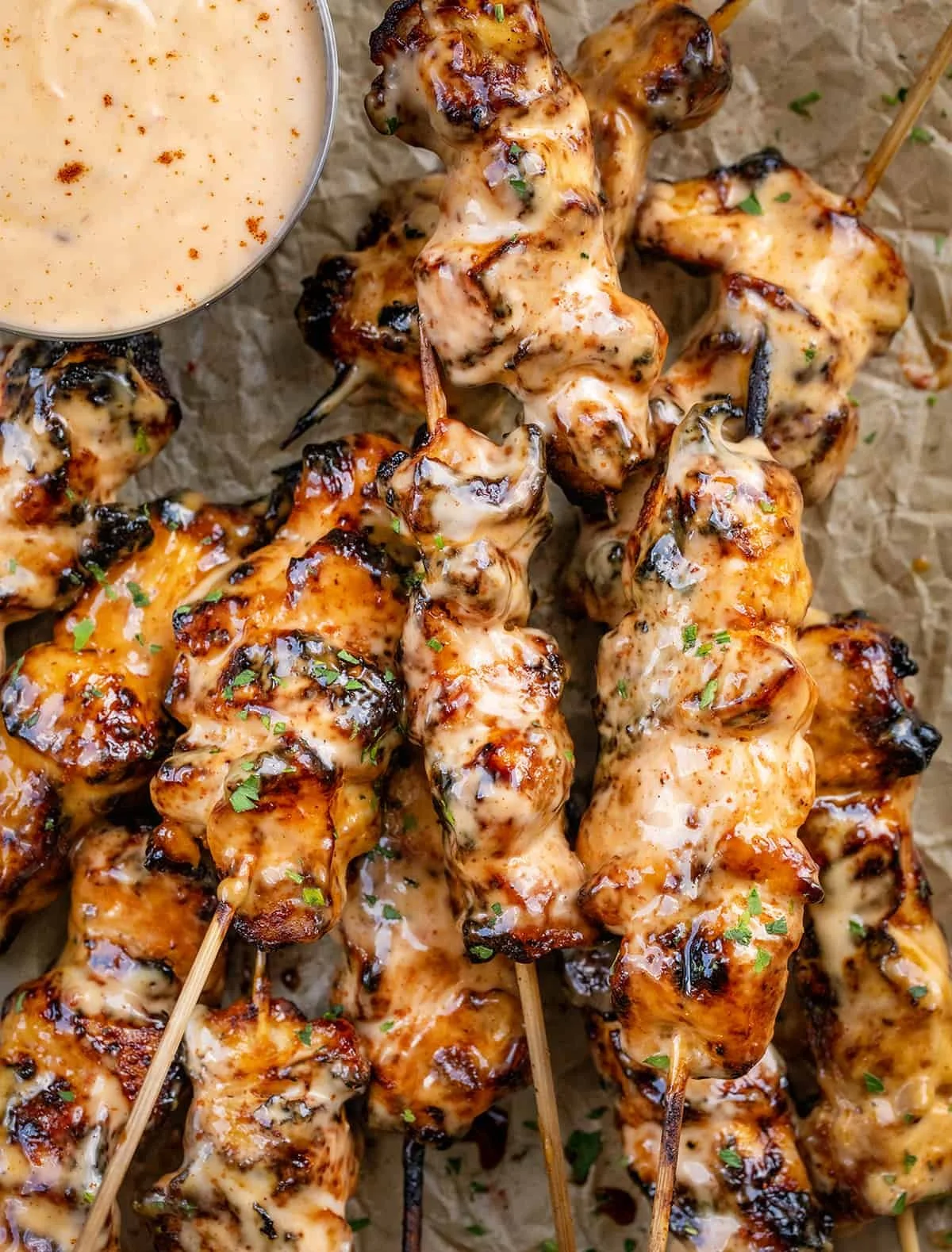 Bang Bang Chicken Skewers with spicy sauce on the grill